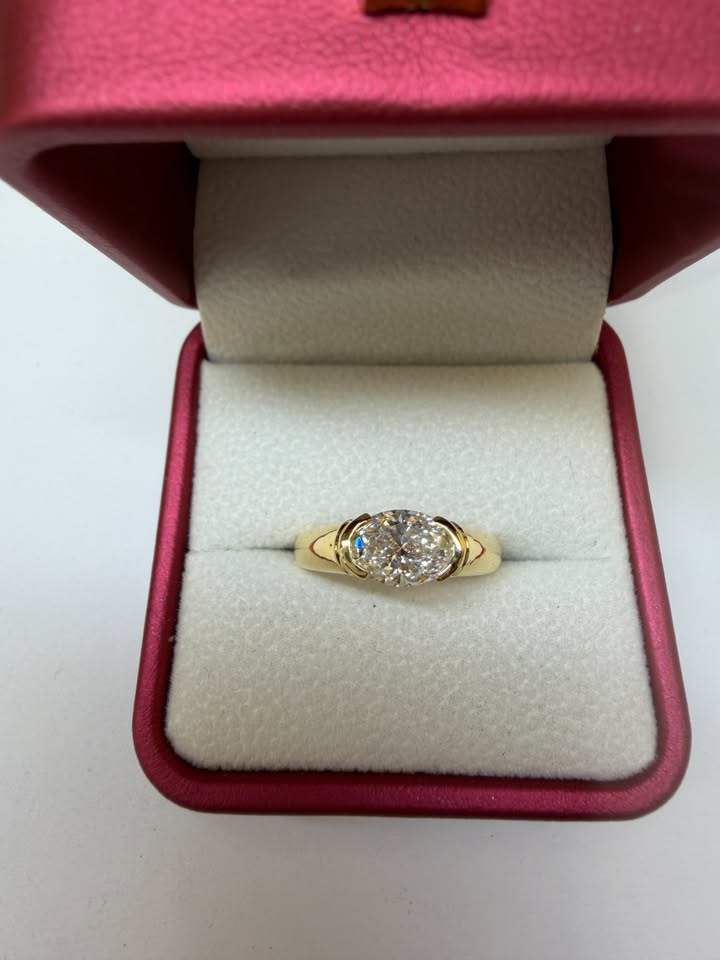 Oval east-west half-bezel ring, 1.5ct, 14K yellow gold