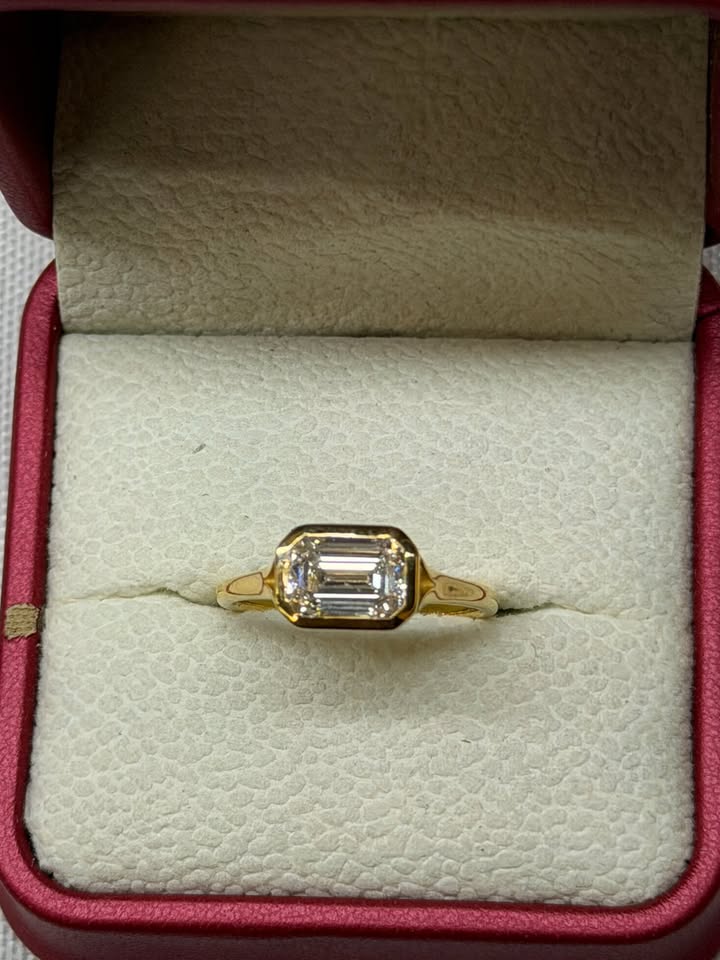 Emerald cut east-west bezel ring, 1.5ct, 14K yellow gold