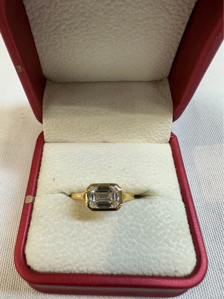Emerald cut east-west bezel ring, top view
